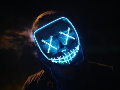 Person in a lighted face mask
