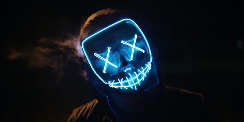Person in a lighted face mask