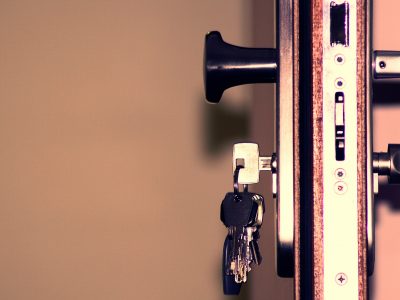 A door lock with keys inserted.